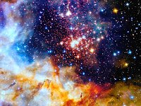 A close-up of far-away space displaying orange and white nebula and many stars