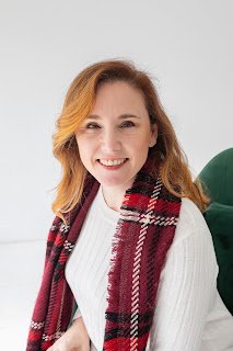 Photograph of Alynda before COVID-19 wearing a white sweater and red scarf suggesting a Christmas photo; Alynda's hair neatly combed and flowing down to her shoulders