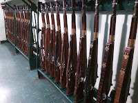 A wall rack full of rifles in a submarine's armory